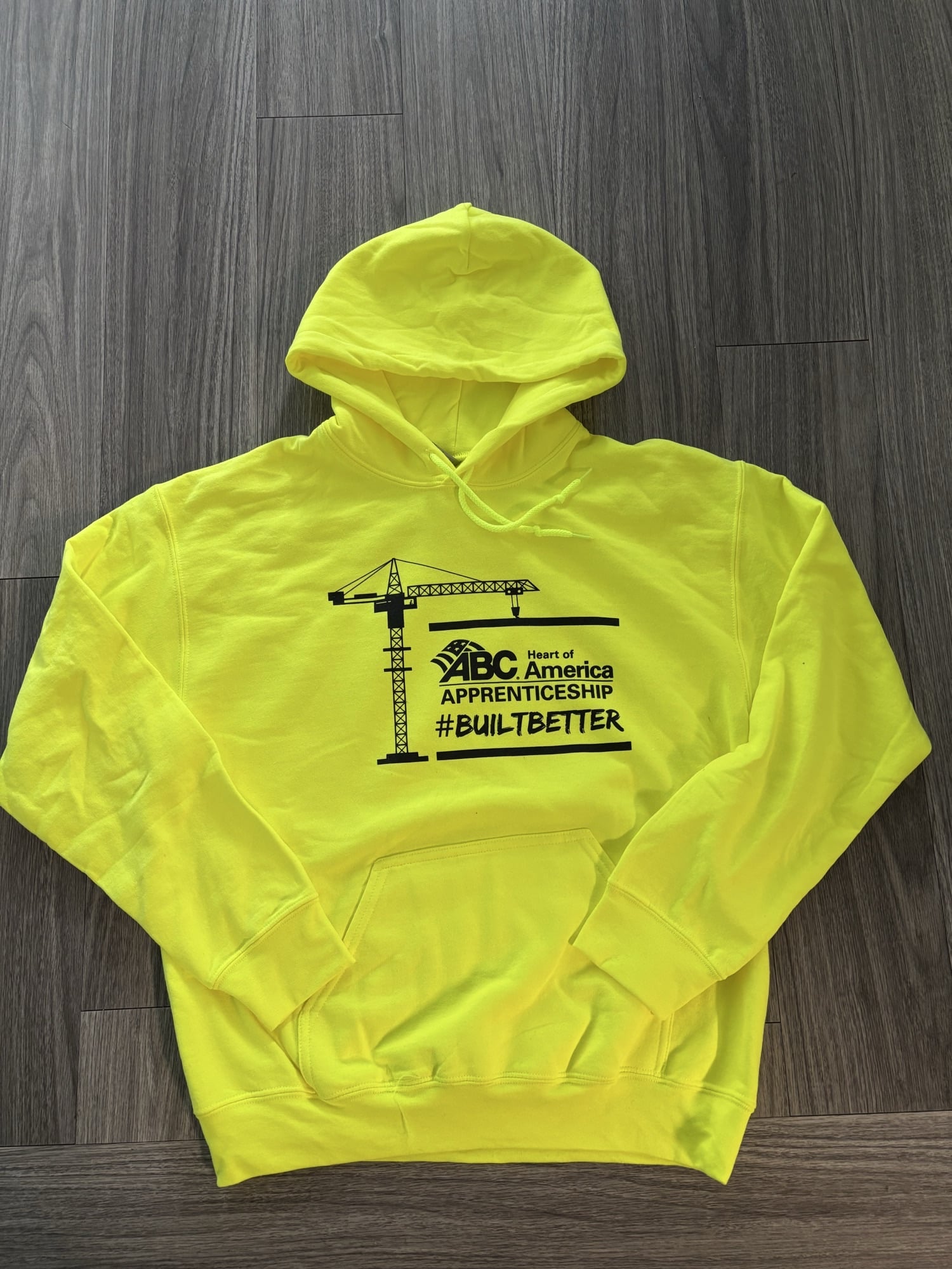 A yellow ABC HOA sweatshirt
